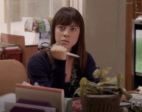 Aubrey Plaza in "Parks & Rec" with scissors in hand, ready to stab