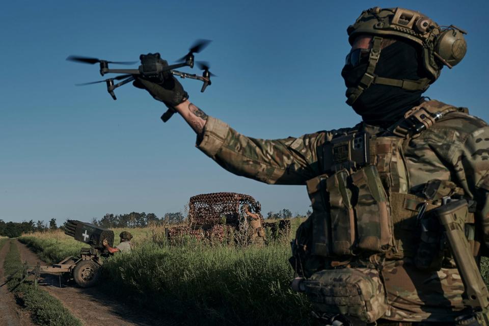 A Ukrainian soldier of the 28th brigade launches a drone at the frontline close t