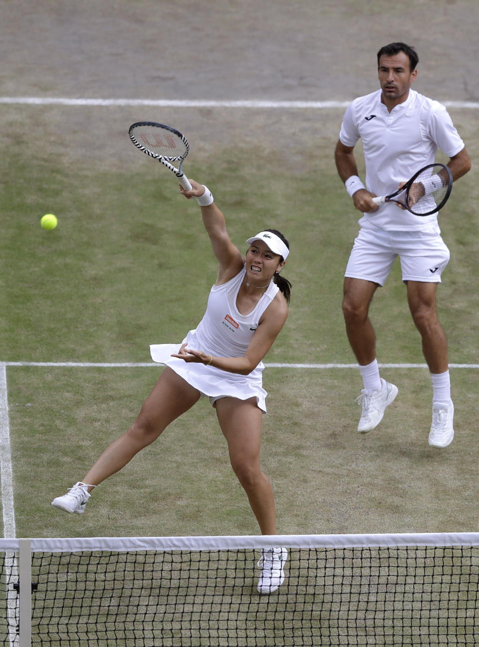 Taiwan's Latisha Chan, left, and Croatia's Ivan Dodig in action against Latvia's Jelena Ostapenko and Sweden's Robert Lindstedt during the mixed doubles final match of the Wimbledon Tennis Championships in London, Sunday, July 14, 2019. (AP Photo/Kirsty Wigglesworth)