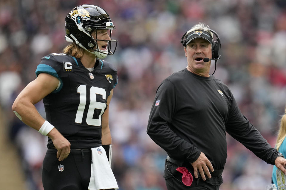 Jacksonville Jaguars quarterback Trevor Lawrence (16) and Jacksonville Jaguars head coach Doug Pederson speak during an NFL football game between the Atlanta Falcons and the Jacksonville Jaguars at Wembley stadium in London, Sunday, Oct. 1, 2023. (AP Photo/Kirsty Wigglesworth)