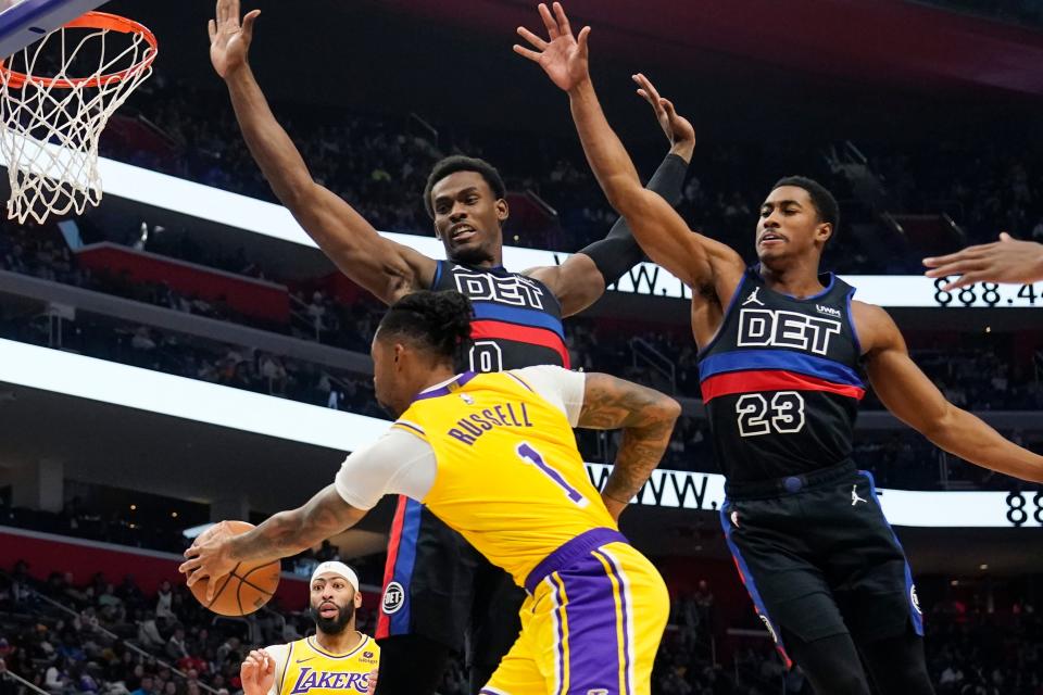 Lakers guard D'Angelo Russell passes as Pistons center Jalen Duren, center, and guard Jaden Ivey defend during the second half of the Pistons' 133-107 loss on Wednesday, Nov. 29, 2023, at Little Caesars Arena.