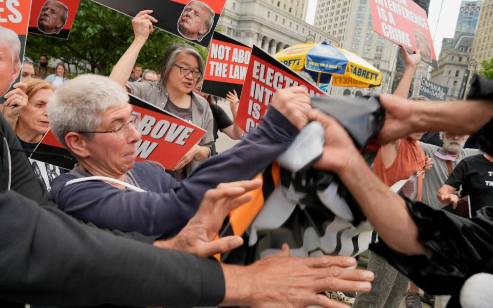 Trump supporters and anti-Trump demonstrators clash outside the Manhattan court