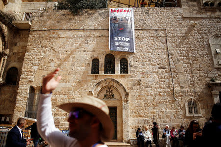 A banner hangs from a wall next to the entrance of the Church of the Holy Sepulchre, in Jerusalem's Old City, February 25, 2018. REUTERS/Amir Cohen