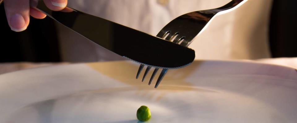 Single green pea on a plate