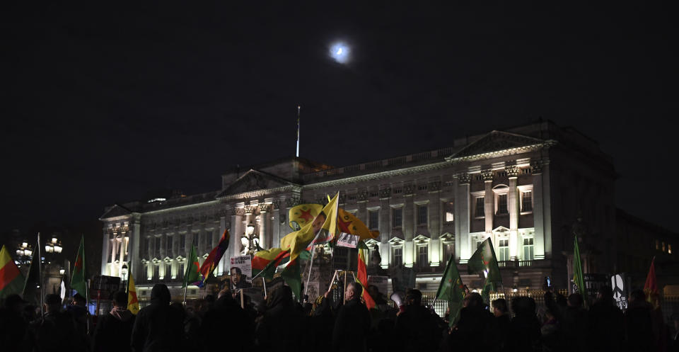 Demonstrators against the NATO summit and U.S. President Donald Trump's visit, gather at Buckingham Palace in London, Tuesday, Dec. 3, 2019. Trump and his NATO counterparts were gathering in London Tuesday to mark the alliance's 70th birthday amid deep tensions as spats between leaders expose a lack of unity that risks undermining military organization's credibility. (AP Photo/Alberto Pezzali)