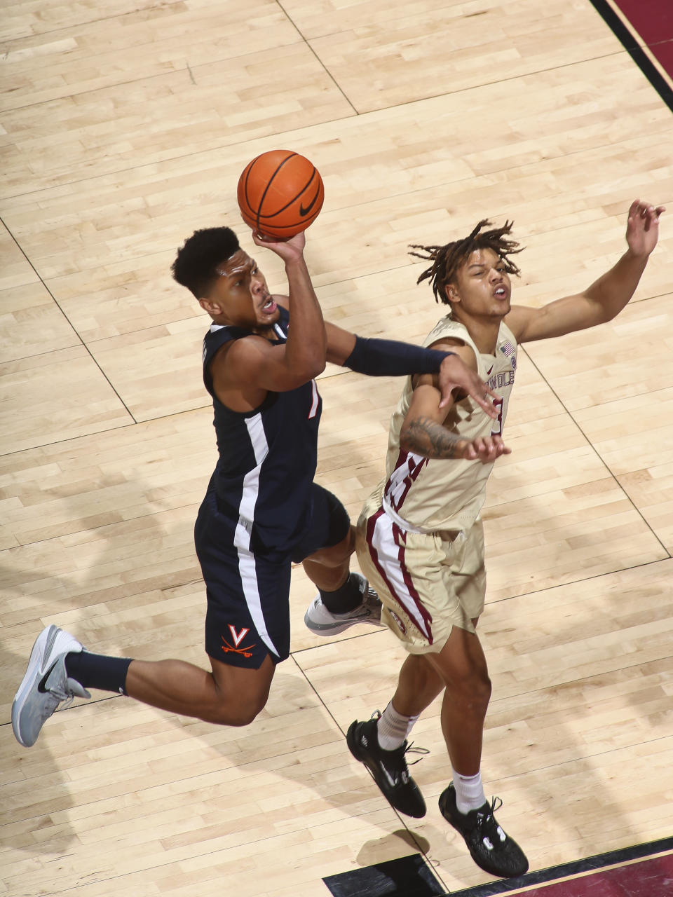 Virginia forward Jayden Gardner (1) misses a layup as he is defended by Florida State forward Cameron Corhen (3) in the first half of an NCAA college basketball game in Tallahassee, Fla., Saturday, Jan. 14, 2023. (AP Photo/Phil Sears)