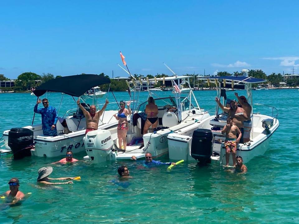 Boaters party and swim while anchored in the Florida Bay behind Key Largo Sunday, May 30, 2021.