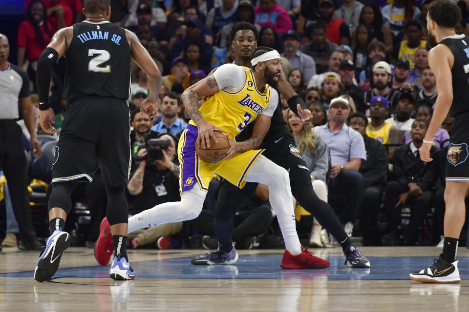 Los Angeles Lakers forward Anthony Davis (3) drives against Memphis Grizzlies forward Jaren Jackson Jr., rear, during the first half in Game 2 of a first-round NBA basketball playoff series Wednesday, April 19, 2023, in Memphis, Tenn. (AP Photo/Brandon Dill)