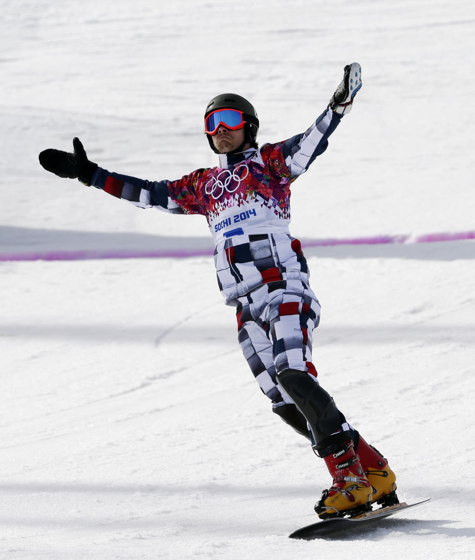 Russia's Vic Wild crosses the finish line to win the gold medal in the men's snowboard parallel slalom final at the Rosa Khutor Extreme Park, at the 2014 Winter Olympics, Saturday, Feb. 22, 2014, in Krasnaya Polyana, Russia. (AP Photo/Andy Wong)