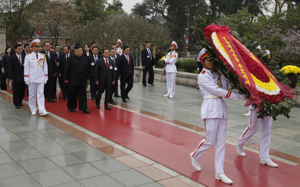 North Korean leader Kim Jong Un, center, attends a wreath laying ceremony at Monument to War Heroes and Martyrs in Hanoi, Vietnam Saturday, March 2, 2019. Kim spent his last day in Hanoi on Saturday, laying large red-and-yellow wreaths at a war memorial and at the mausoleum of national hero Ho Chi Minh as he continued an official state visit meant to cement his image as a confident world leader after his summit breakdown with President Donald Trump. (Kham/Pool Photo via AP)