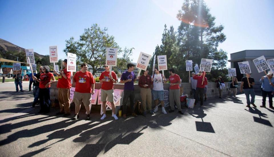 Members of the California Faculty Association picket outside a Cal Poly alumni event at the Performing Arts Center on Friday, Oct. 27, 2023, in support of higher state university salaries.