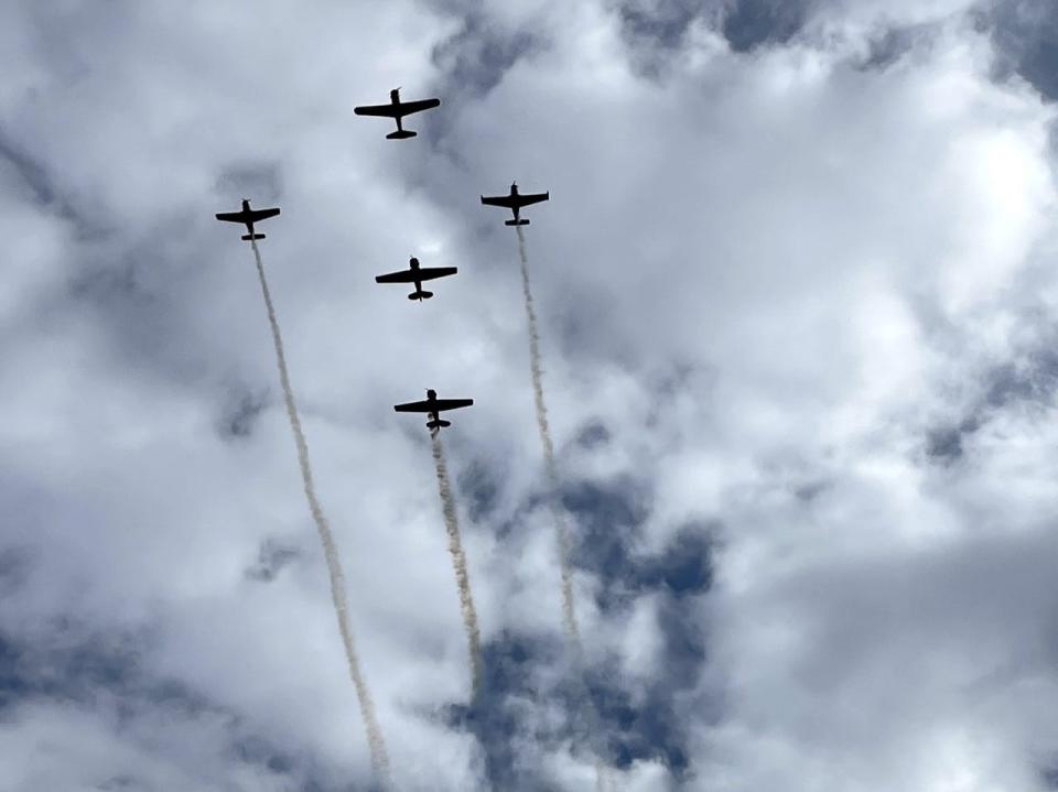 A five-plane formation with three World War II-era aircraft is seen overhead during a flyover at the WT Veterans Day event in November 2022.