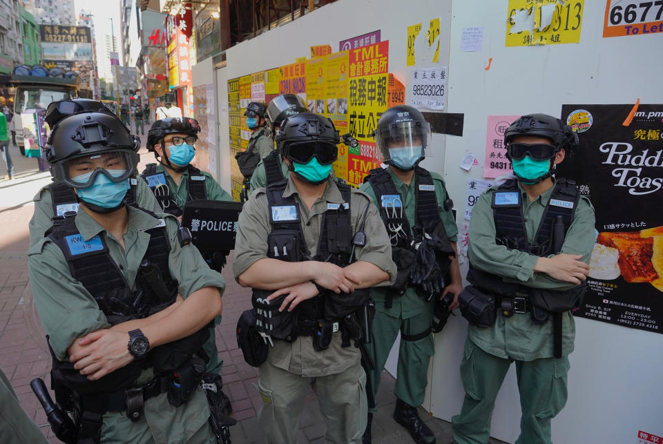 Police officers stand guard as people gather during a pro-democracy rally supporting human rights and to protest against Beijing's national security law in Hong Kong, Sunday, June 28, 2020. (AP Photo/Vincent Yu)