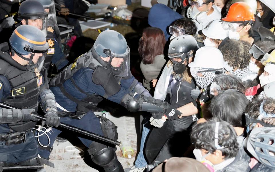 Police officers confront protesters at UCLA