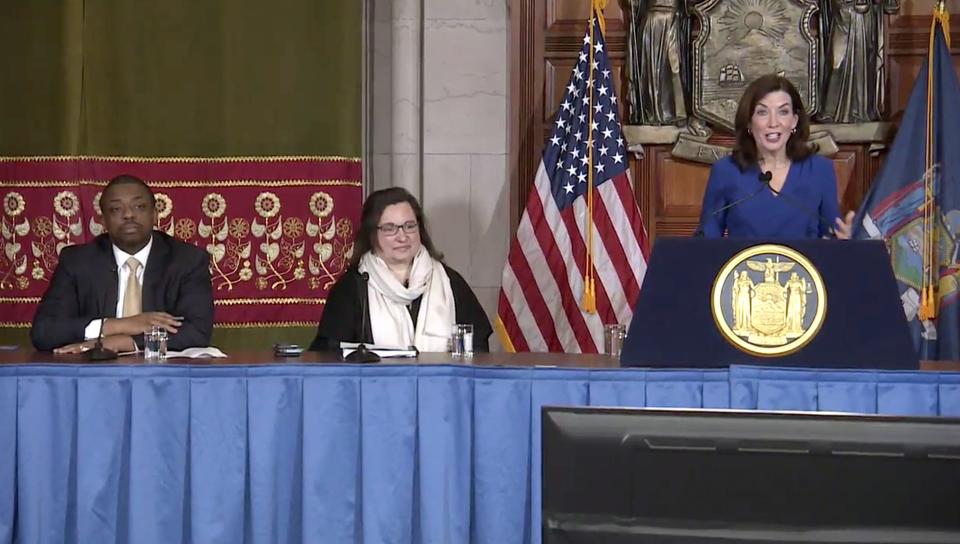 In this image take from video, New York Gov. Kathy Hochul, right, speaks about the state budget during a news conference, Thursday, April 7, 2022, in Albany, N.Y. Lieutenant Gov. Brian Benjamin, left, and Secretary to the Governor Karen Persichilli Keogh looked on. (Office of the Governor of New York via AP)