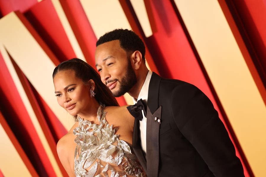 (Left to Right) Chrissy Teigen and EGOT winner John Legend sparkle at the 2024 Vanity Fair Oscar Party, hosted by Radhika Jones at Wallis Annenberg Center for the Performing Arts in Beverly Hills. (Amy Sussman/Getty Images)