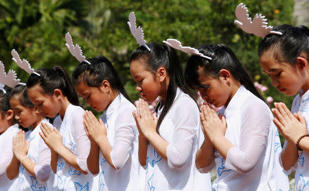 Schoolgirls perform during the 50th anniversary of the My Lai massacre in My Lai village, Vietnam March 16, 2018. REUTERS/Kham