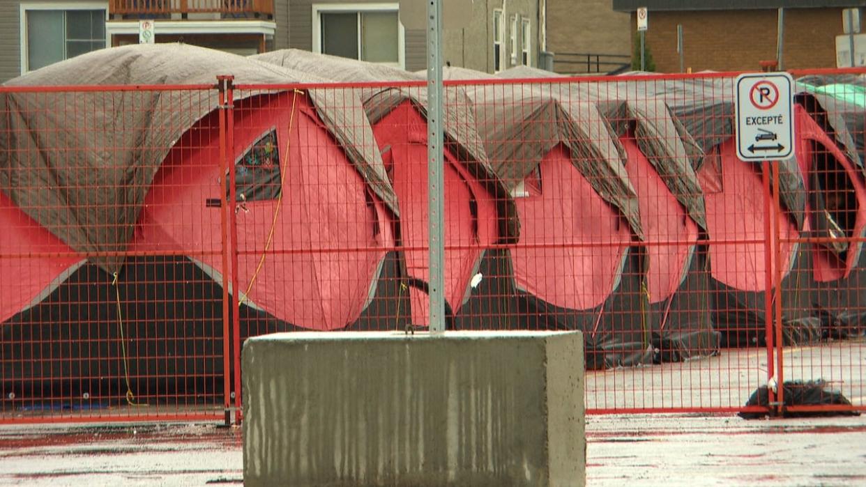 A view of some of the heated, winter tents set up in front of the Robert-Guertin Centre arena. Once the demolition of the arena begins, people living in tents and other accommodations outside will have to move. (Radio-Canada - image credit)