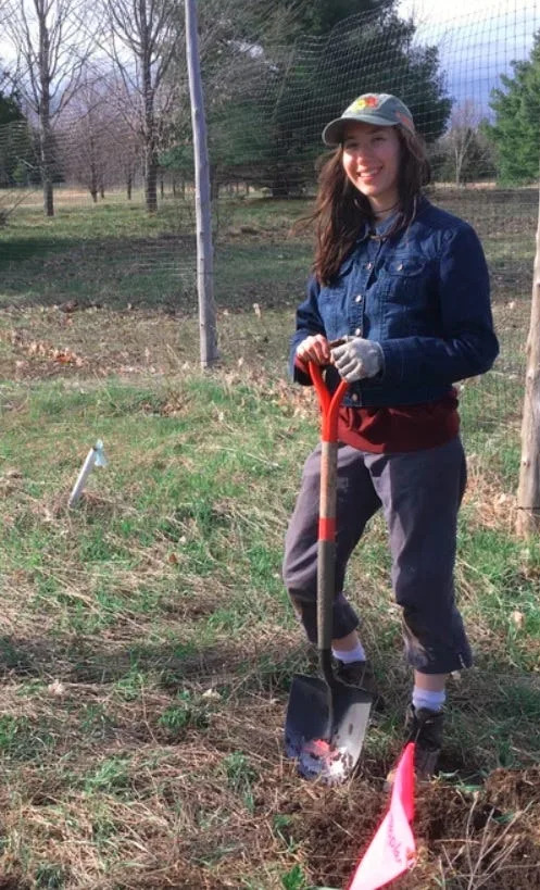 NIACS climate adaptation specialist Madeline Baroli, founder of the Assisted Tree Range Expansion Project, pauses during planting in northwest Lower Michigan in the spring of 2020.