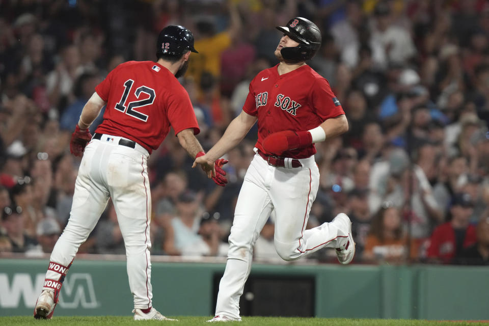 Boston Red Sox's Enrique Hernandez, right, celebrates with Connor Wong (12) after scoring on a single by Rob Refsnyder against the Texas Rangers during the sixth inning of a baseball game Thursday, July 6, 2023, in Boston. (AP Photo/Steven Senne)