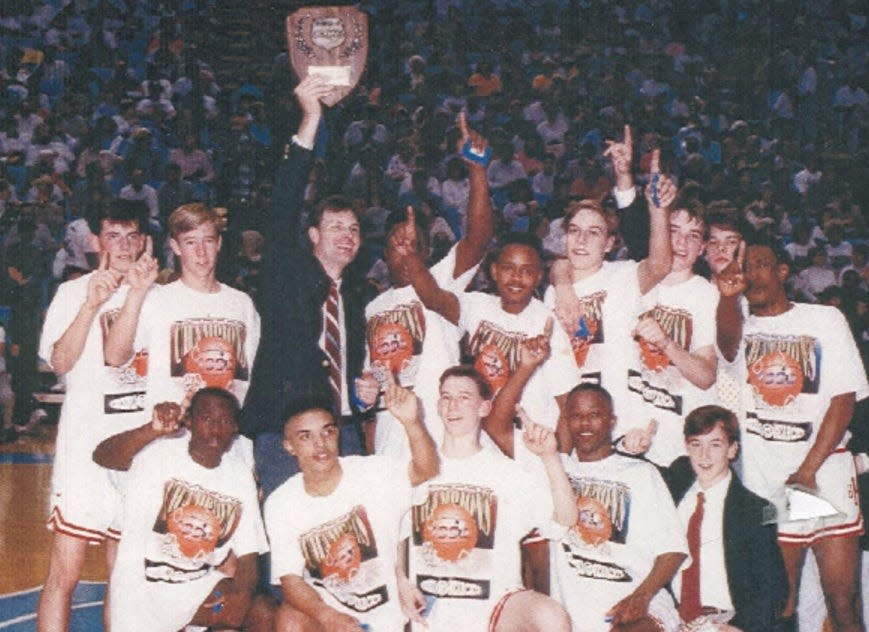 The 1992 Hendersonville High boys basketball team celebrates its win in the 1-A state title game in Chapel Hill.