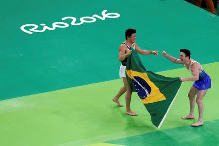 2016 Rio Olympics - Artistic Gymnastics - Final - Men's Floor Final - Rio Olympic Arena - Rio de Janeiro, Brazil - 14/08/2016. Arthur Mariano (BRA) of Brazil and Diego Hypolito (BRA) of Brazil celebrate after taking bronze and silver respectively. REUTERS/Athit Perawongmetha