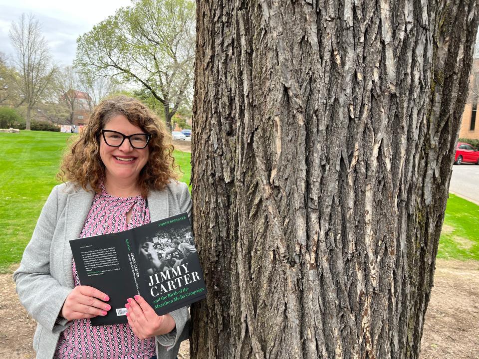 Professor Amber Roessner on the University of Tennessee campus with her 2020 book, "Jimmy Carter and the Birth of the Marathon Media Campaign."