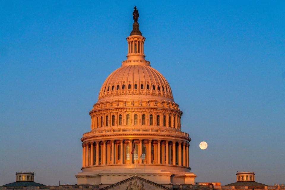 PHOTO: The Snow Moon sets behind the US Capitol Dome on February 25, 2024, in Washington, DC. (J. David Ake/Getty Images)