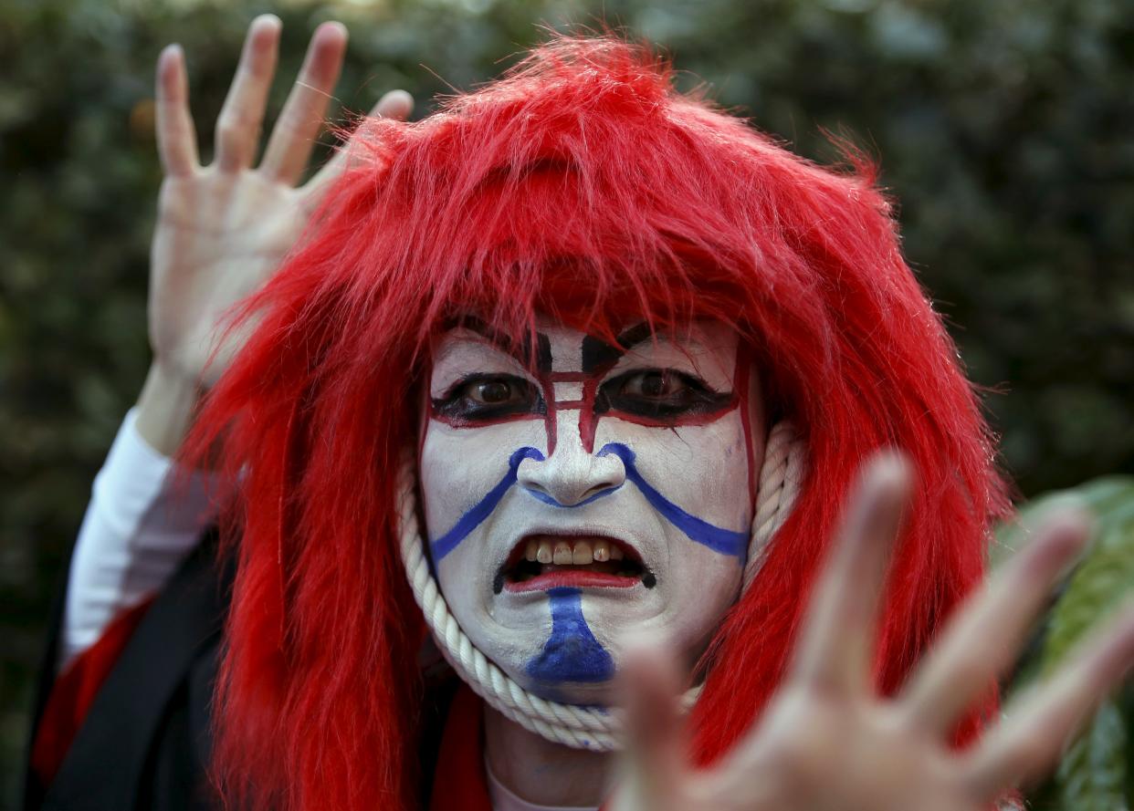 A participant in costume poses for a picture after a Halloween parade in Kawasaki, south of Tokyo