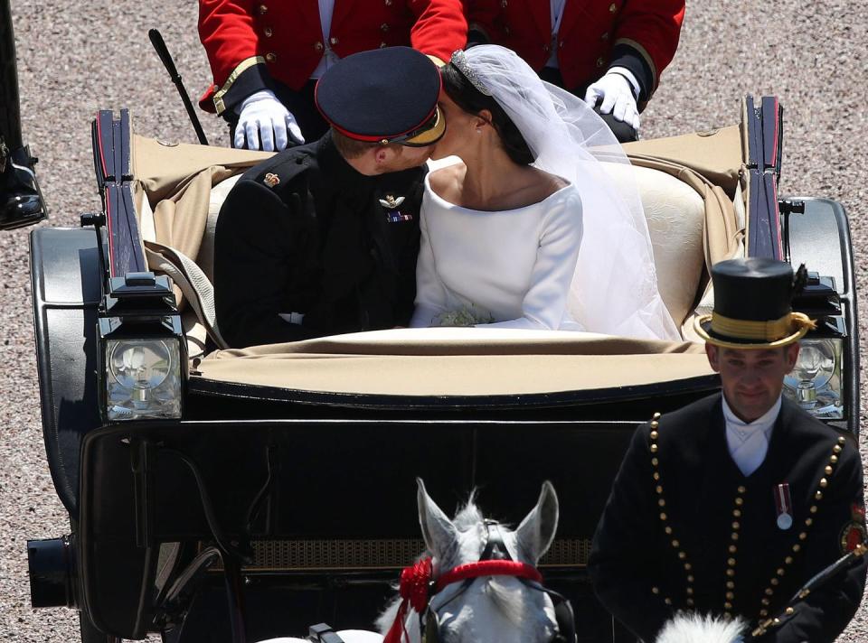 <p>Though the royal family has traditionally been pretty reserved on the PDA front, the happy couple sneaked in <a href="https://www.townandcountrymag.com/society/tradition/a20758315/prince-harry-meghan-markle-royal-wedding-second-kiss/" rel="nofollow noopener" target="_blank" data-ylk="slk:a second public smooch;elm:context_link;itc:0;sec:content-canvas" class="link ">a second public smooch</a> during their post-ceremony procession. (Their first public kiss was shared, in traditional fashion, in front of St. George's Chapel immediately following the ceremony.) </p>