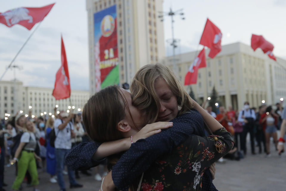 Protesters react during an opposition rally at Independent Square in Minsk, Belarus, Monday, Aug. 24, 2020. Belarusian authorities on Monday detained three leading opposition activists who have helped spearhead a wave of protests demanding the resignation of the country's authoritarian president Alexander Lukashenko following a disputed election.(AP Photo/Sergei Grits)