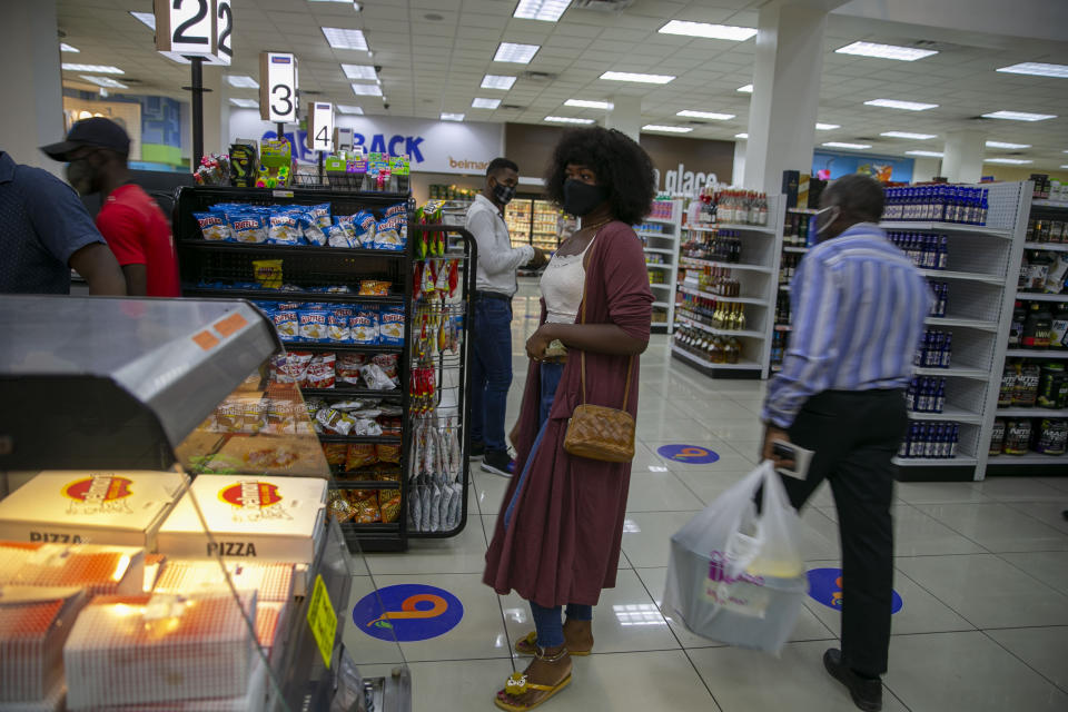 Transgender Semi Kaefra Alisha Fermond stands in line to pay for birthday candles at a supermarket before returning to the Kay Trans Haiti center to celebrate her 24th birthday, in Port-au-Prince, Haiti, Friday, Aug. 7, 2020. Disha Fermond, who is enjoying celebrating her birthday as a woman for the first time, said she had a traumatic childhood because neighbors didn't want her to play with their children. (AP Photo/Dieu Nalio Chery)