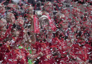 Liverpool's Jordan Henderson lifts the trophy and celebrates after winning the English FA Cup final soccer match between Chelsea and Liverpool, at Wembley stadium, in London, Saturday, May 14, 2022. (AP Photo/Kirsty Wigglesworth)