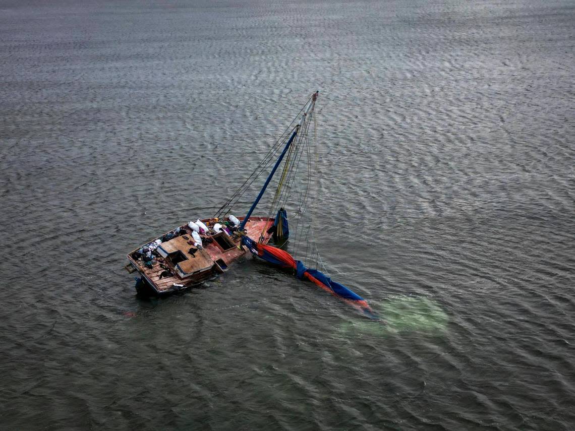 A Haitian freighter used by Haitian migrants to travel to the United States sits in a sandbar off Key Largo in the Florida Keys on Jan. 14, 2023.