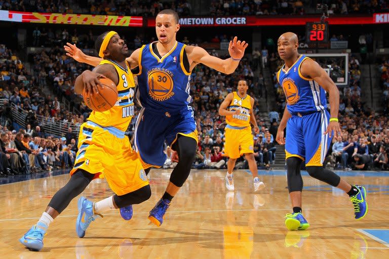 Ty Lawson (L) of the Denver Nuggets drives with the ball against Stephen Curry of the Golden State Warriors on April 23, 2013. The Warriors connected on 51-of-79 shots from the field, 64.6 percent, to set a club single-game playoff record for shooting accuracy