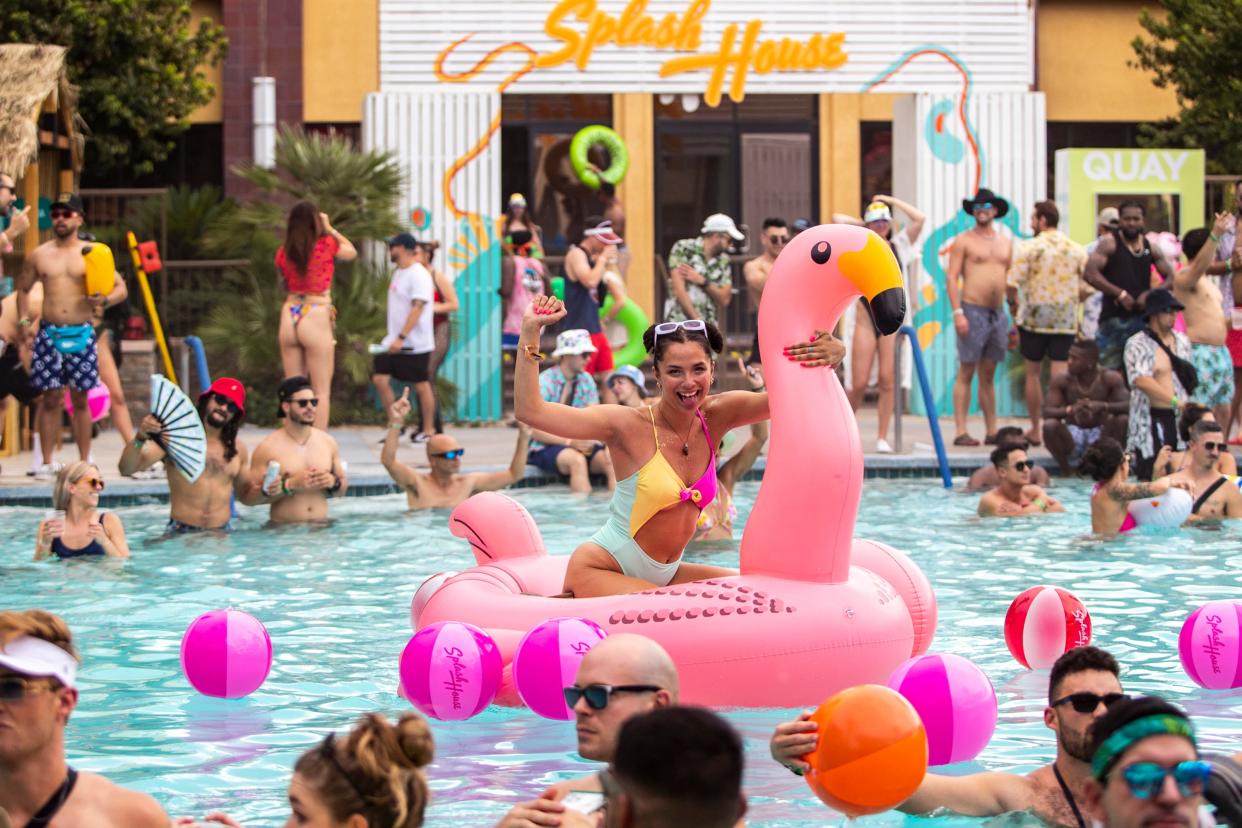 Ayesa Kearns smiles for the camera on an inflatable flamingo in the pool during weekend two of Splash House at Renaissance Hotel in Palm Springs on Saturday, Aug. 13, 2022.