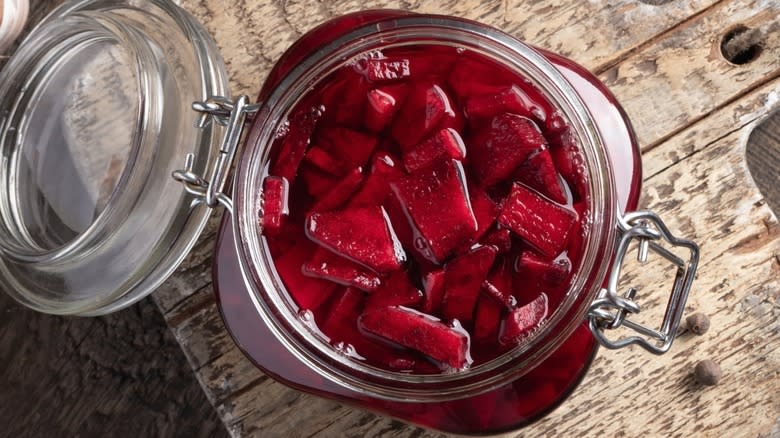 Top-down view of pickled beets in a glass jar