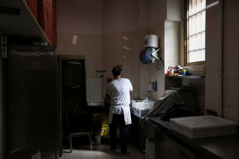 Migrants at work in the kitchen of a Milan restaurant