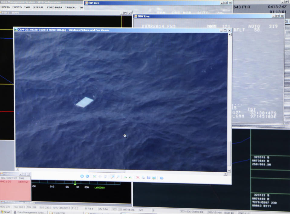 A photo taken off a computer monitor onboard a Royal New Zealand Air Force P-3 Orion, shows an object floating in an area within the search zone of the missing Malaysia Airlines Flight 370 in the Southern Indian Ocean off the coast of Western Australia, Friday, March 28, 2014. Australian Maritime Safety Authority has not confirmed any information about this object. Australian officials said that objects spotted floating in the search area need to be recovered and inspected before they can be linked to the plane. The objects, first spotted Friday, include two rectangular items that were blue and gray, and ships on the scene will attempt to recover them, the AMSA said. (AP Photo/Tony Cheng, Pool)