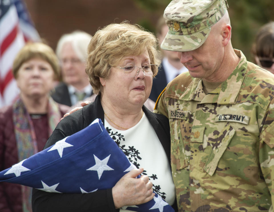 Major Jon Richardson, of the Utah National Guard, comforts Mary Ann Turner, the daughter of 2nd Lt. Lynn W. Hadfield, after the graveside service for her father at Veterans Memorial Park in Bluffdale, Utah, Thursday, March 21, 2019. The Salt Lake City Tribune reported Thursday that Army Air Forces 2nd Lt. Lynn W. Hadfield's remains, returned from Germany, were buried 74 years to the day of Hadfield's crash during a bomber plane run from France to Germany just months before the war's end. (Rick Egan/The Salt Lake Tribune via AP)