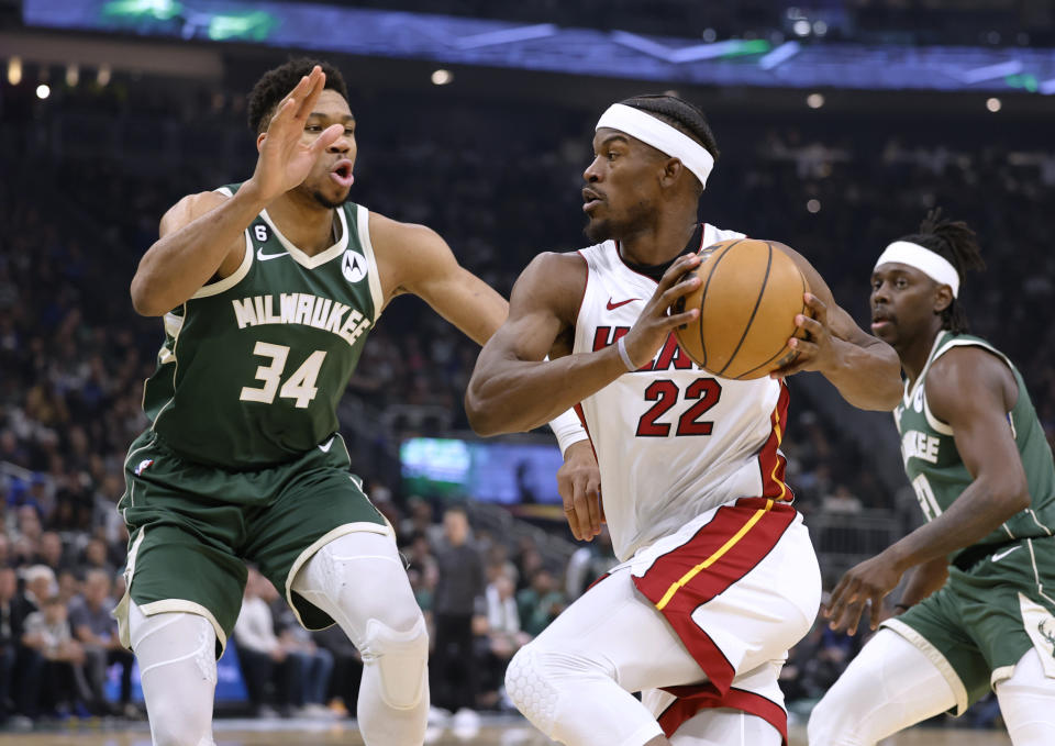 Miami Heat forward Jimmy Butler (22) drives against Milwaukee Bucks forward Giannis Antetokounmpo (34) during the first half of Game 5 in a first-round NBA basketball playoff series Wednesday, April 26, 2023, in Milwaukee. (AP Photo/Jeffrey Phelps)