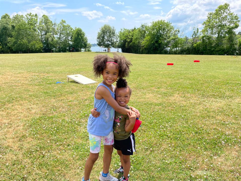 Noelle Fleming, 12, and sister Paige Fleming, 3, share a hug after a game of Bean Bag Toss at the first Spring Lawn Games Festival held at Carl Cowan Park Sunday, May 22, 2022.