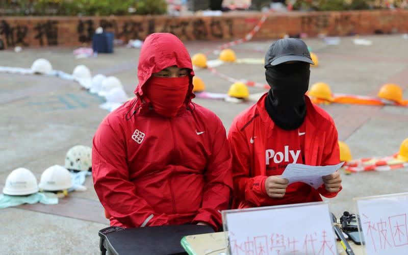 Protesters address the media at the campus of the Polytechnic University in Hong Kong