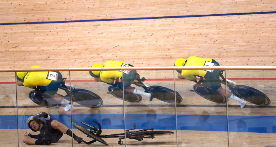 <p>(Top, from L) Australia's Sam Welsford, Australia's Lucas Plapp and Australia's Kelland O'Brien ride past New Zealand's Aaron Gate after he crashed during the men's track cycling team pursuit finals during the Tokyo 2020 Olympic Games at Izu Velodrome in Izu, Japan, on August 4, 2021. (Photo by Odd ANDERSEN / AFP) (Photo by ODD ANDERSEN/AFP via Getty Images)</p> 