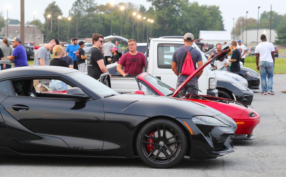 Car enthusiasts hang out at an informal gathering at Pit Daddy's BBQ outside Smyrna earlier this month.