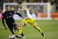 Columbus Crew's Liam Fraser, right, dribbles past Inter Miami's Gregore during the second half of an MLS soccer match Saturday, Oct. 16, 2021, in Columbus, Ohio. (AP Photo/Jay LaPrete)