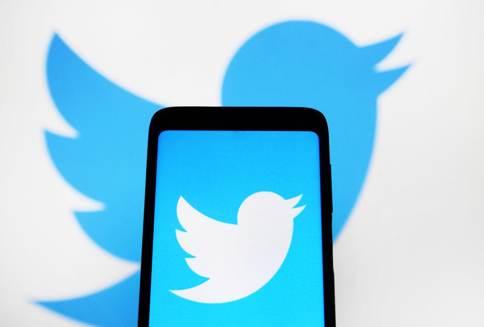 UKRAINE - 2021/01/11: In this photo illustration a Twitter logo is seen displayed on a smartphone and a computer screen in the background. (Photo Illustration by Pavlo Gonchar/SOPA Images/LightRocket via Getty Images)