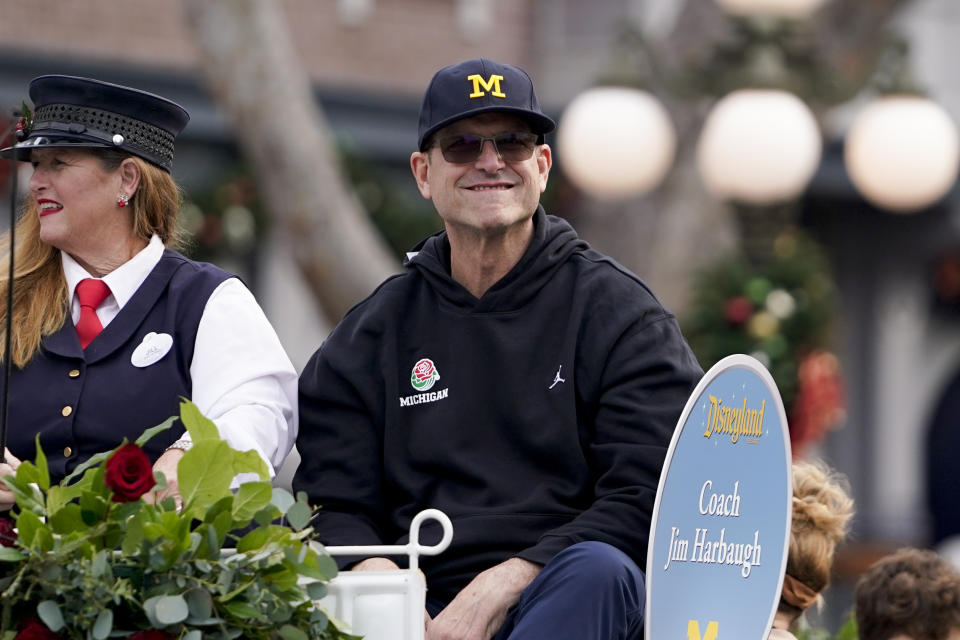 Michigan coach Jim Harbaugh smiles during a welcome event for the team at Disneyland on Wednesday, Dec. 27, 2023, in Anaheim, Calif. Michigan is scheduled to play against Alabama on New Year's Day in the Rose Bowl, a semifinal in the College Football Playoff. (AP Photo/Ryan Sun)