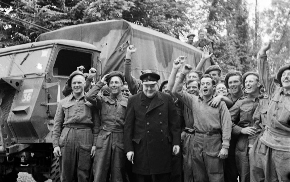 Winston Churchill pictured on his visit to Normandy with cheering British soldiers - Mirrorpix