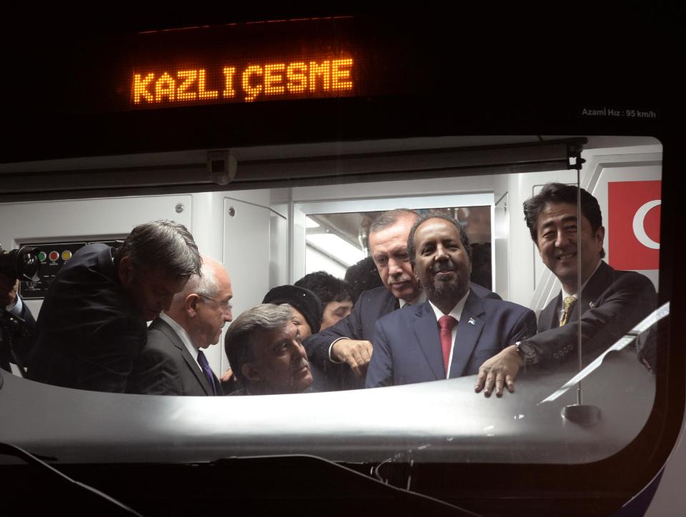 Japanese Prime Minister Shinzo Abe, right, his Turkish counterpart Recep Tayyip Erdogan, third right, Turkey's President Abdullah Gul, third left, and Somalia's President Hassan Sheikh Mohamud, second right, wait inside a train to cross the Bosporus after the inauguration of the tunnel called Marmaray in Istanbul, Turkey, Tuesday, Oct. 29, 2013. Turkey is for the first time connecting its European and Asian sides with a railway tunnel set to open Tuesday, completing a plan initially proposed by an Ottoman sultan about 150 years ago. The Marmaray, is among a number of large infrastructure projects under the government of Prime Minister Recep Tayyip Erdogan that have helped boost the economy but also have provoked a backlash of public protest.(AP Photo)